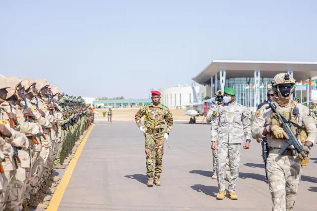 General Assimi Goïta reviewing troops in military attire