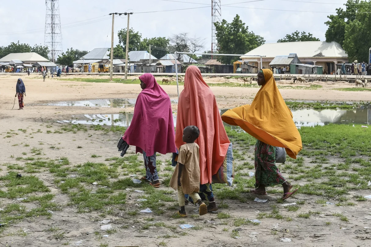 Survivors and relatives of victims of a suspected Boko Haram attack walk in Babban Gide on September 4, 2024. At least 81 people died and several remain missing following an assault by presumed Boko Haram jihadists in Yobe State, northeastern Nigeria.