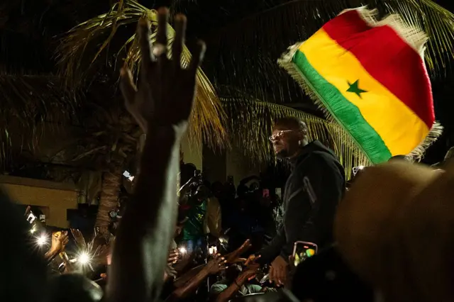 Supporters of Ousmane Sonko celebrating outside his home in Dakar, May 23, 2026