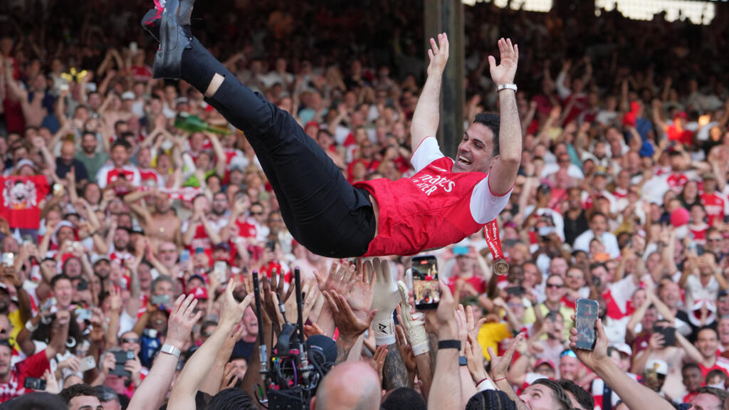 Arsenal manager Mikel Arteta is carried triumphantly by players celebrating their Premier League title after the Crystal Palace vs Arsenal match in London, England, on May 24, 2026.