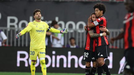 Niçois players Jonathan Clauss and Dante celebrate after Clauss scores the opening goal in the Ligue 1/Ligue 2 playoff match against Saint-Étienne on May 29
