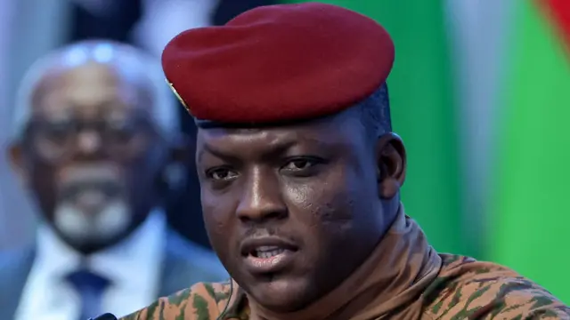 Close-up of Ibrahim Traoré wearing a beige military uniform and red beret.