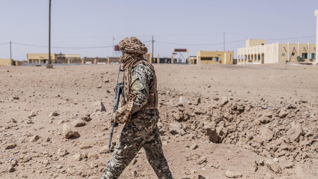 A soldier from the National Liberation Front of Azawad inspects a bomb crater in Kidal on May 14, 2026, caused by a Malian Air Force strike.